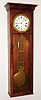 Jeweler's regulator, 8 day, time only, weight driven movement with pinwheel escapement and heavy gridiron pendulum in a mahogany veneer case with ornate fretwork around white enamel dial, c1880