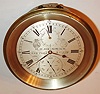H. H. Heinrich, New York, marine chronometer of eight day duration, the movement with gilt plates, blued steel screws, spring detent escapement, cut bimetallic balance with cylindrical weights for temperature compensation, blued steel helical balance spring, diamond end stone in blued setting, the escapement, third, and fourth wheels mounted as a sub assembly which can be removed without complete disassembly of the movement, brass bezel with beveled glass, silvered Roman numeral dial with black outer 5 minute markers, wind indicator, engraved with makers name and location, and No. 559,gold hands with blued steel seconds, contained in a heavy brass tub marked with owners name H. A. Urnhammer, with key, c1890