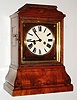 Black Forest shelf or bracket clock, spring powered time and strike movement of unknown duration, with brass bushed wooden plates, recoil escapement and count wheel striking on a gong, brass shell pendulum with wood and metal rod,  white painted Roman numeral dial with black painted steel hands, the dial mounted to a walnut veneered board with brass line and star inlay, and finished with a gilt ogee molding, protected by a ripple molded door with glass, walnut veneered spruce case with ripple molding at top, and brass inlaid bombe base, door in left side of case for strike correction, c1860