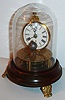 Reproduction of Briggs pat. rotary pendulum timepiece (30-hour), on a walnut base with 3 cast feet and iron winder under base, with glass dome. C.2010