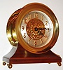 Chelsea Clock Co., Boston, Mass., "Centennial Edition" ships bell clock, eight day time and ships bell strike movement with platform lever escapement, silvered dial with pierced gilt center and applied gilt Arabic numerals, black painted steel hands, polished brass case with hinged bezel, mounted to a walnut base supported by polished brass ball feet, No. 0031, c1997