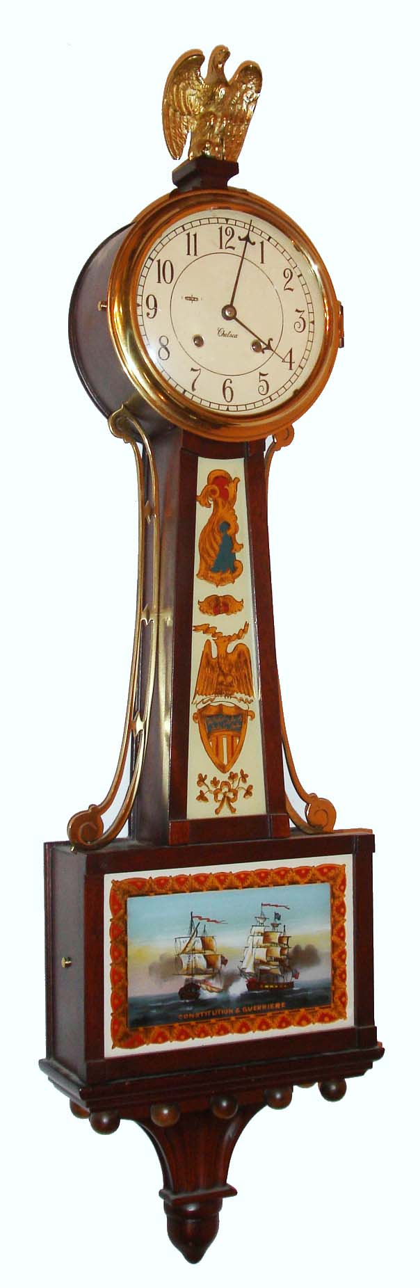Chelsea Clock Co., Chelsea, Mass., "Willard Banjo Clock 3/4 Size" wall clock, 8 day, time and ship's bell strike spring driven movement with lever escapement in a mahogany case with reverse painted throat and lower tablets of USS Constitution Versus HMS Guerriere and painted metal dial, c1976 s#800831 — Antique Clocks Price Guide