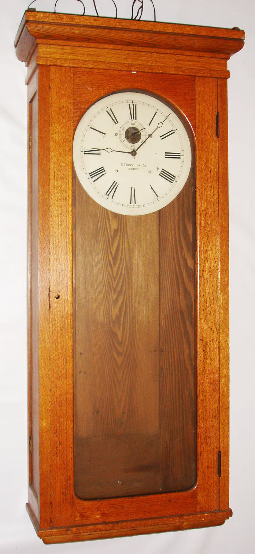 E. Howard &amp; Co., Boston, Mass., "Regulator No. 89" wall clock, time only, self-winding electric movement in an oak case with painted metal dial, c1925 — Antique Clocks Price Guide