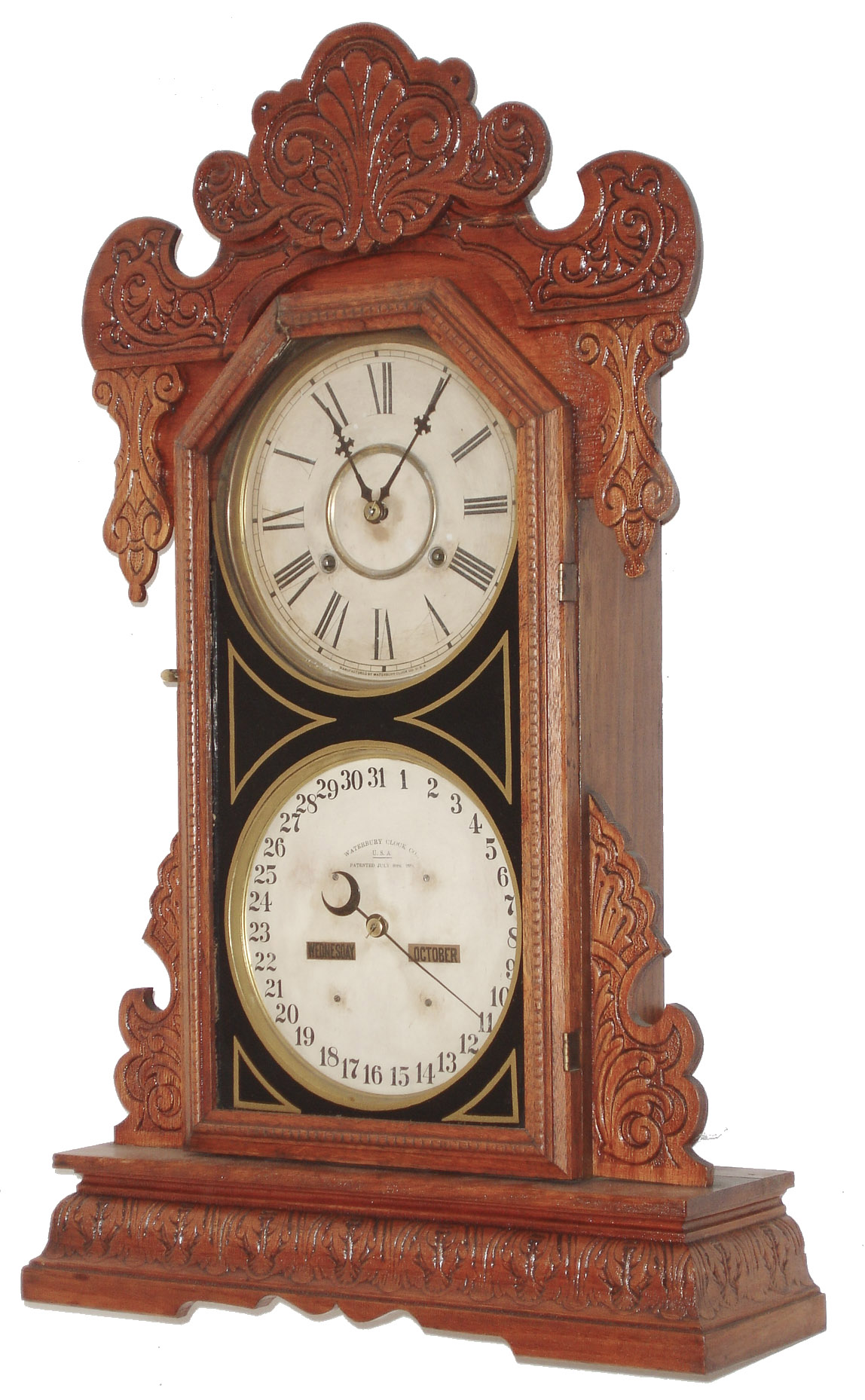 Waterbury Clock Co., Waterbury, Conn., "Oswego" 8 day, time and strike, double dial gingerbread style calendar clock. We could not find this example in the catalog. There is a partial label on the back that reads "American Manufacturing-" .  This model was most likely made for them.   c1900 — Antique Clocks Price Guide