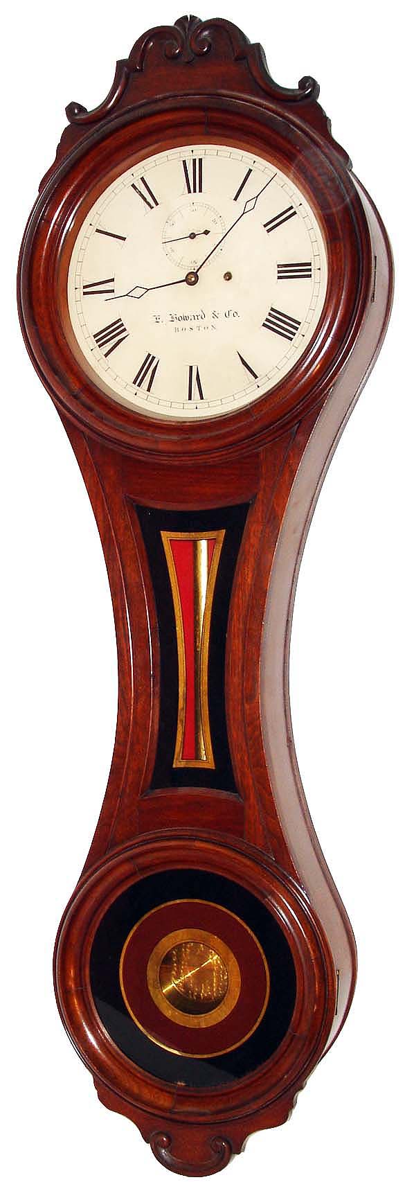 E. Howard &amp; Co., Boston, Mass., "No. 6 Regulator", figure eight wall clock, 8 days, time only, weight driven movement in a black walnut case with a painted iron dial, reverse painted tablets and damascene pendulum bob, c1874 — Antique Clocks Price Guide