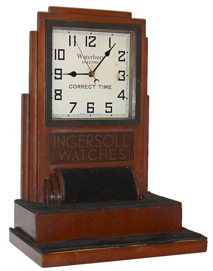 Waterbury Clock Co., Waterbury, Conn., "Electric Advertising" for Ingersoll Watch Co., shelf clock, time only, electric driven movement in a mahogany case with velvet lining to display Ingersoll watches, c1930 — Antique Clocks Price Guide
