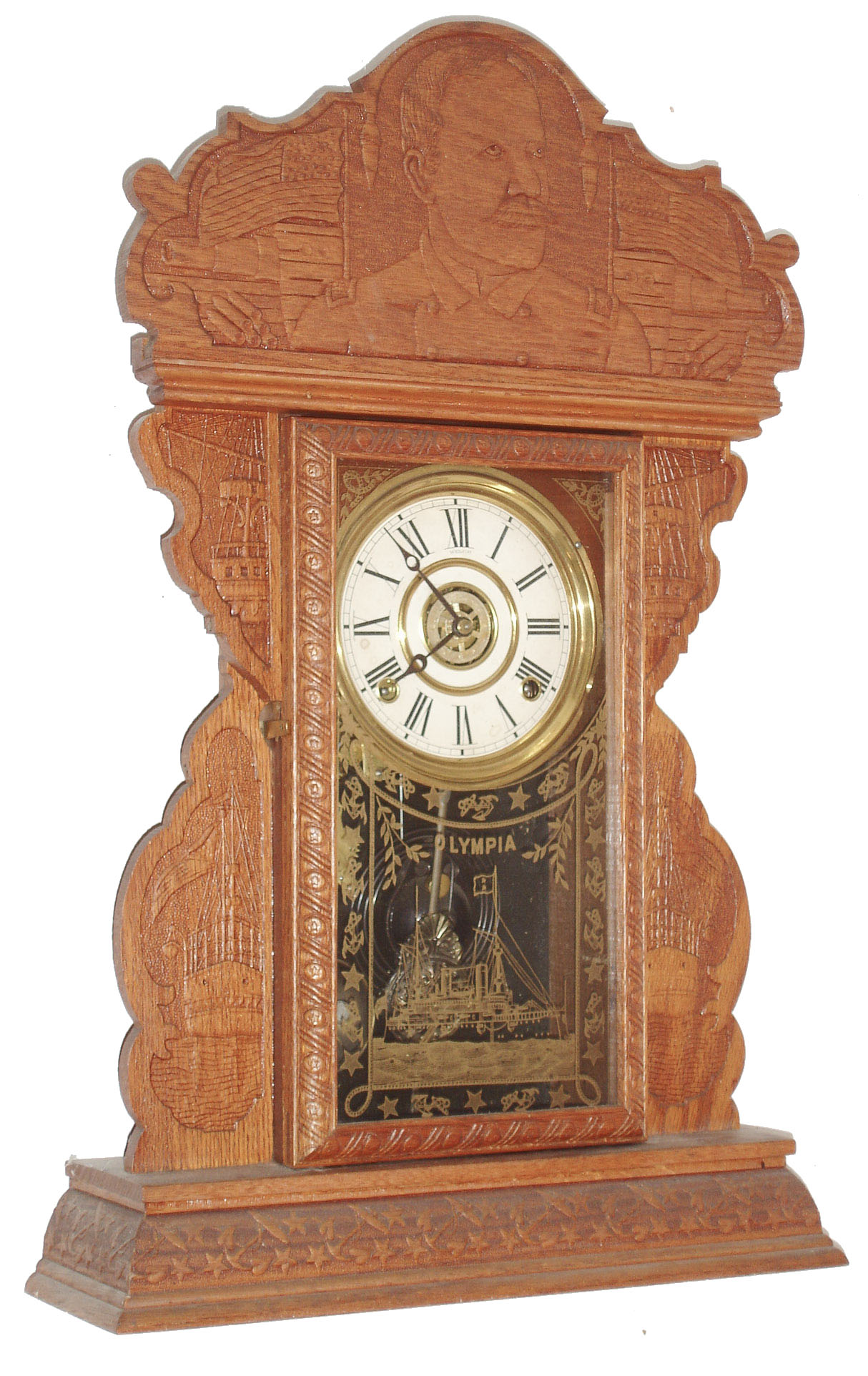 E. N. Welch Mfg. Co., Forestville, Conn., "Dewey", 8 day, time and strike, and alarm, pressed oak case kitchen clock.  This was one of the commemorative series produced by Welch.   c1900 — Antique Clocks Price Guide