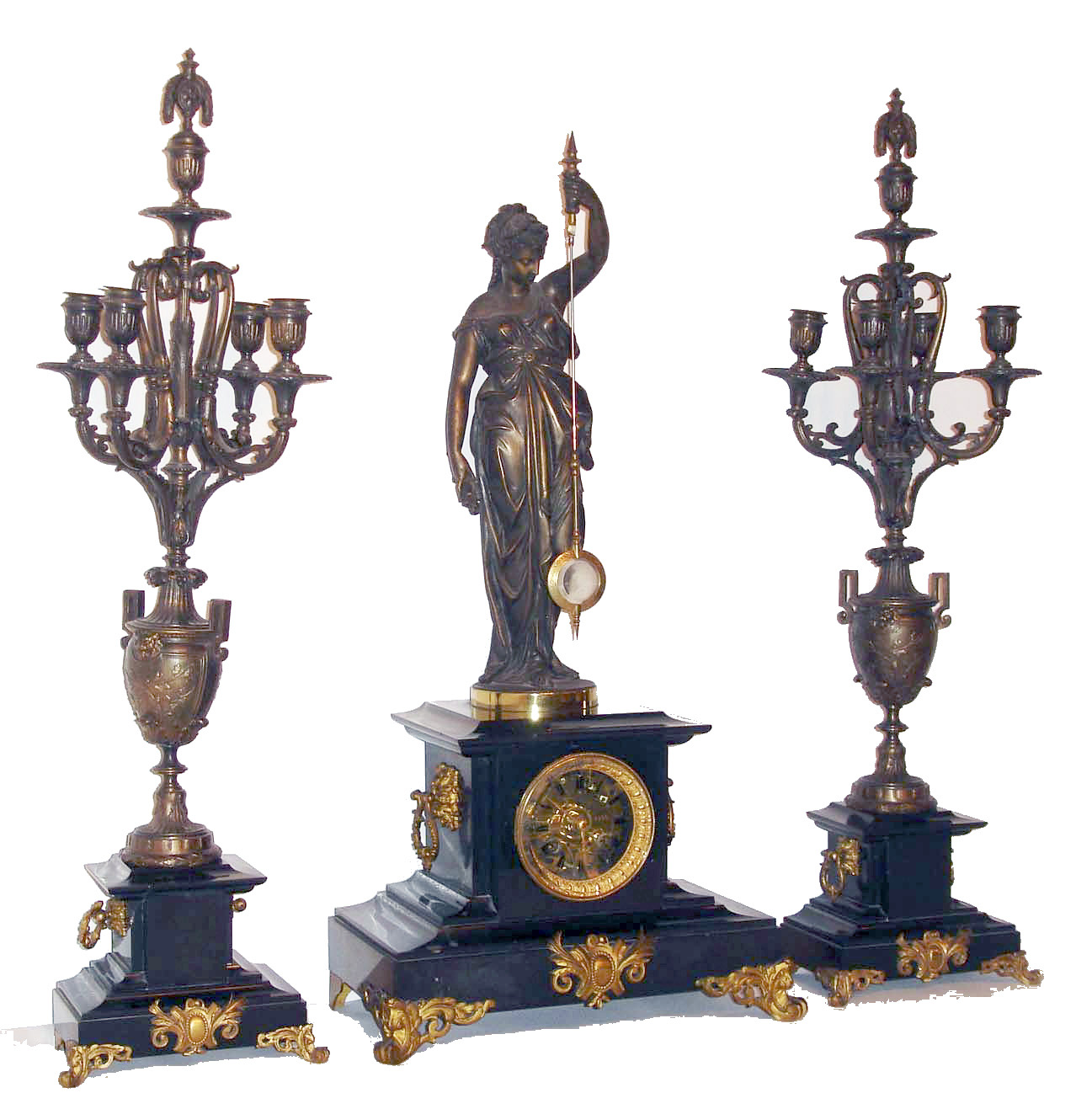 Rare French mystery clock by Guilmet, black slate with gilt and patinated ornament, with candelabra garniture, the signed time and strike, movement with crank and stirrup escapement, a bronzed spelter figure of a woman on top of the case, holding the pendulum, the pendulum impulsed through the nearly imperceptible movement of the gilt base on which the figure stands, candelabra in patinated spelter with Classically inspired ornament, on black slate bases matching the clock, later glass dial with black painted Roman numerals allowing the action of the movement to be observed, the original black slate dial with gilt Roman numerals is included with the clock, gilt bezel with thick beveled glass, gilt steel hands, pendulum with glass center, c1875 — Antique Clocks Price Guide