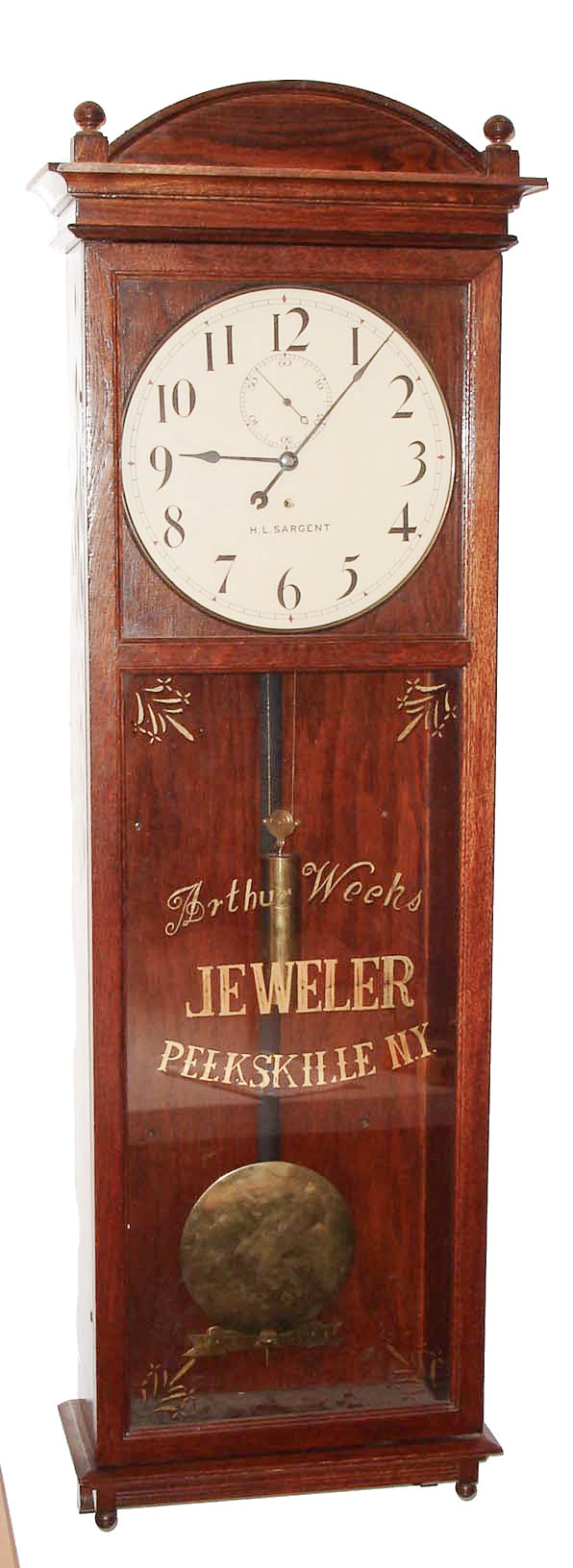 Seth Thomas Clock Co., Thomaston, Conn., "Regulator No. 20", wall clock, 8 days, time only, weight driven movement in an oak case with painted metal dial and a silk screened advertisement for "Arthur Weeks JEWELER PEEKSKILLE N.Y.", c1909 — Antique Clocks Price Guide