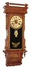 William L. Gilbert Clock Co., Winsted, Conn., "Sharon", wall clock, 8 days, time, strike and McCabe's patent with digital calendar, spring driven movement in an oak case with reverse painted tablet and papered metal dial, c1890