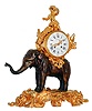 French figural clock, 8 days, time and count wheel strike pendule a Paris movement by Marti, contained in a gilt drum carried on the back of a patinated bronze figure of an elephant standing on a gilt bronze base with rococo style ornament, the drum with gilt foliage and seated figure holding a cluster of grapes, white enamel Roman numeral dial with Arabic outer 5 minute markers, signed "Costantin a Paris Grie de la Madeline", gilt Louis XV style hands, bezel with thick beveled convex glass, c1865