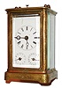 France, Franche - Comte region carriage clock, 8 days, time and strike, movement with alarm, calendar and repeating the hours on demand, nicely engraved and gilded brass case, thick beveled glasses at top and sides, the bell contained in the base, polished brass movement with exposed striking work mounted on back plate, platform with cylinder escapement, white enamel Roman numeral dial with alarm and date sub dials, blued steel Breguet style hands, c1860