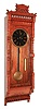 Waterbury Clock Co, "Regulator No 4", "Rosedale", 8 days, weight oak and burl veneer wall timepiece. c1885 This case design was made by both Waterbury and Welch and offered as a two weight timepiece.  This model has an A frame type Waterbury movement. that was not used in the Welch model but a similar looking A frame movement with solid plates was used by Waterbury in some of their regulators.