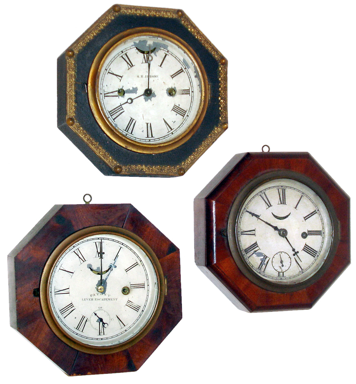 Clocks- 3 (Three): (1) S. B. Jerome, New Haven, Conn., Leather covered octagon case lever movement time and strike, wall clock. (2) Waterbury Clock Co., Waterbury, Conn., Mahogany veneered octagon case lever movement wall timepiece. (3) Waterbury Clock Co., Waterbury, Conn., Mahogany veneered octagon case lever movement wall timepiece. — Antique Clocks Price Guide