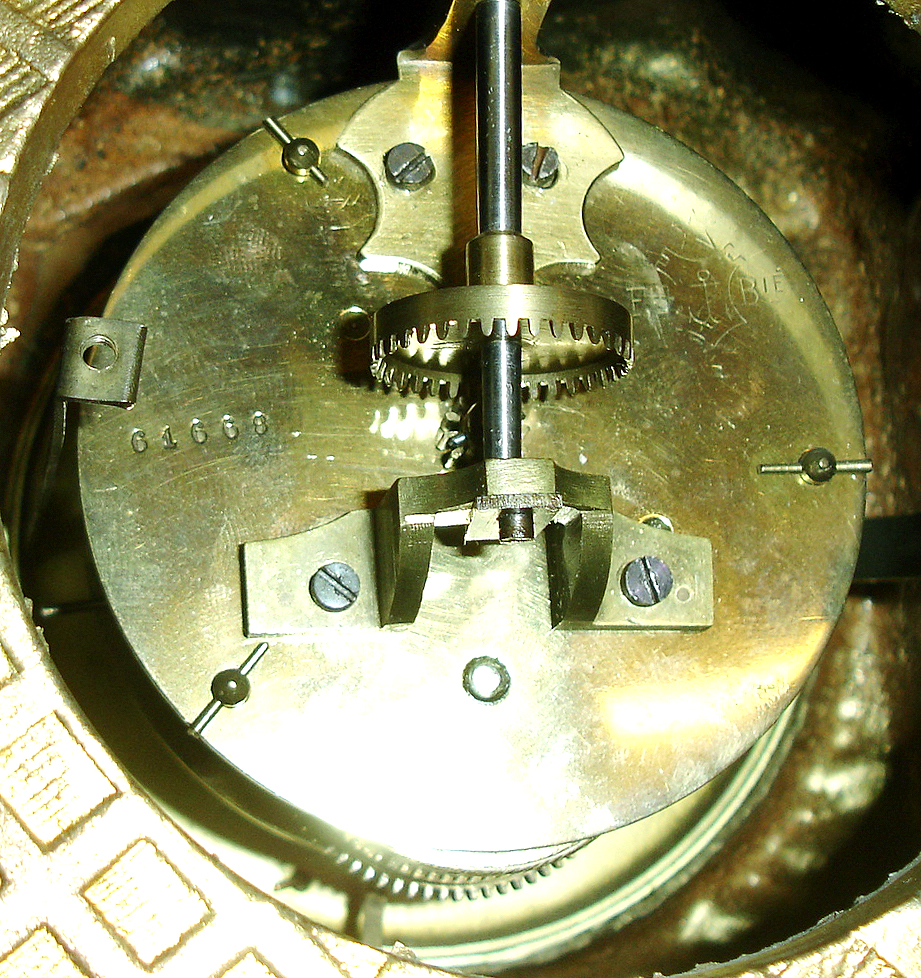 French night clock, an unusual adaptation of the design of Victor Pierret incorporating a pendulum clock with standard dial, the gilt spelter case with classical and rococo ornament, case top with rotating Roman numeral milk glass globe containing a candle holder for illumination at night and turned and engraved brass indicator, front with Roman numeral white enamel dial and blued steel hands, 8 days, time only movement with Brocot escapement, c1880. — Antique Clocks Price Guide