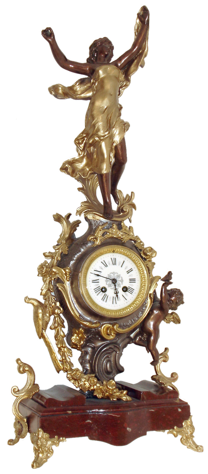 French figural mantel clock, red marble base with gilt scroll feet, the case with gilt and patinated rococo style ornament, trailing vines and flowers, at right a putto holding a bird, the top with female figure, her head back and with outstretched arms, gilt bezel with beveled glass, Roman numeral white enamel dial, blued steel hands, 8 days, time and strike, Pendule a Paris movement, c1890 — Antique Clocks Price Guide