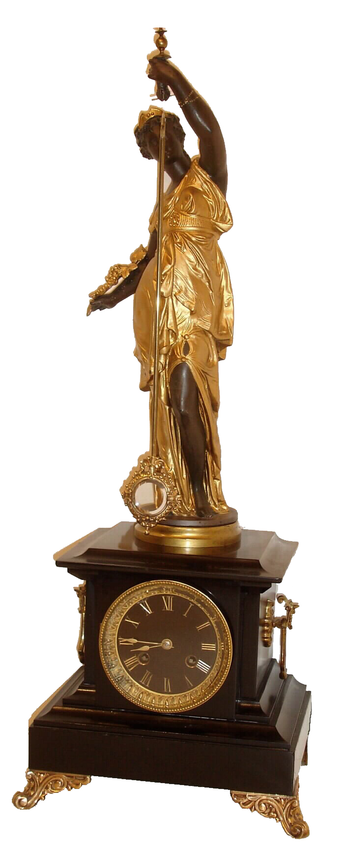 French, "Mystery Clock", the movement with crank &amp; stirrup escape, contained in a black marble case; the painted spelter statue of a robed female holds the suspended pendulum, which swings back and forth with no apparent impulse, black slate dial with incised and gilt Roman numerals, c1885 — Antique Clocks Price Guide