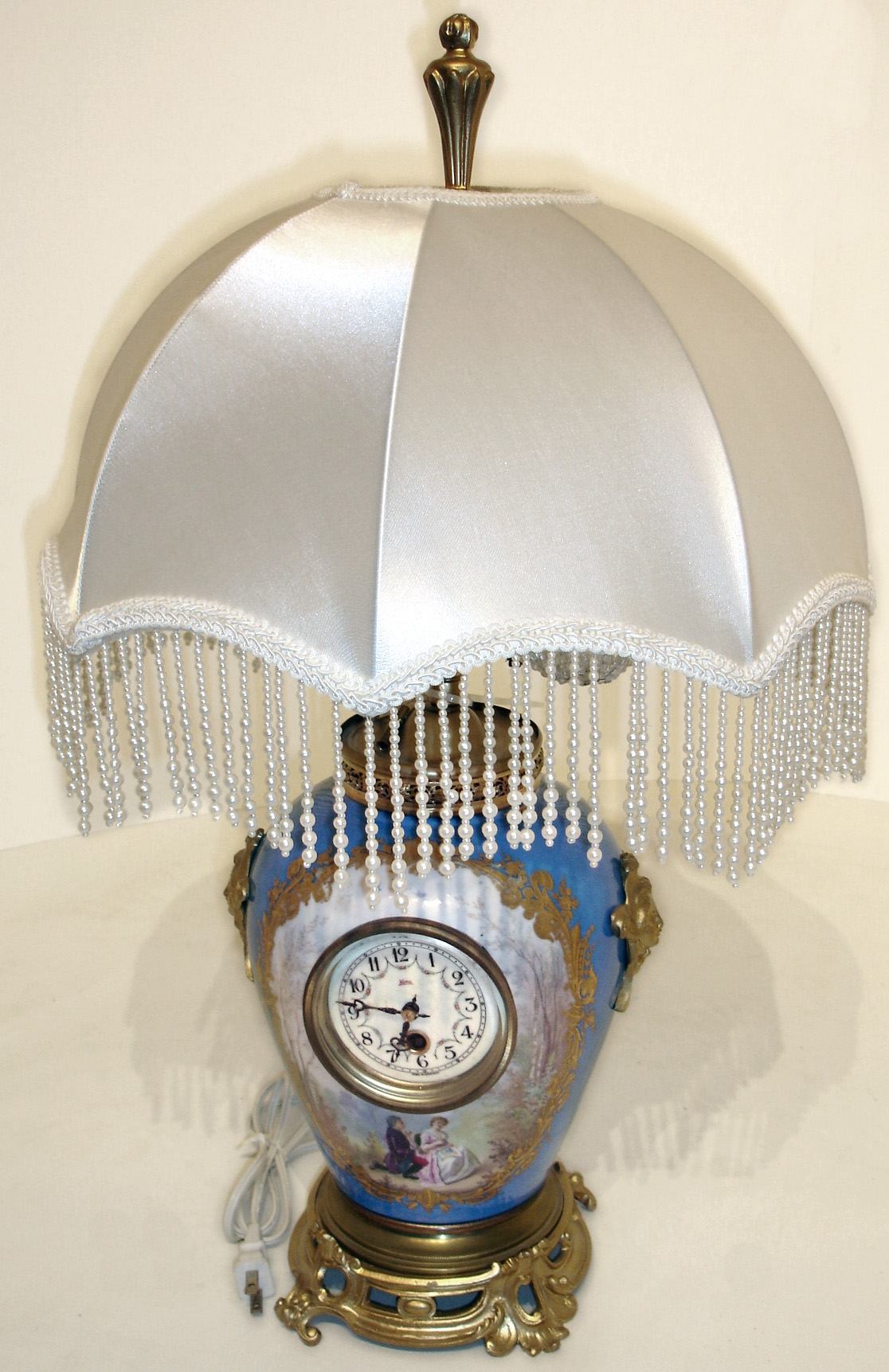 German "Koma" 8 days, timepiece mounted in painted porcelain and gilt metal electric lamp with old cut glass bulbs and cloth shade, early 20th century — Antique Clocks Price Guide