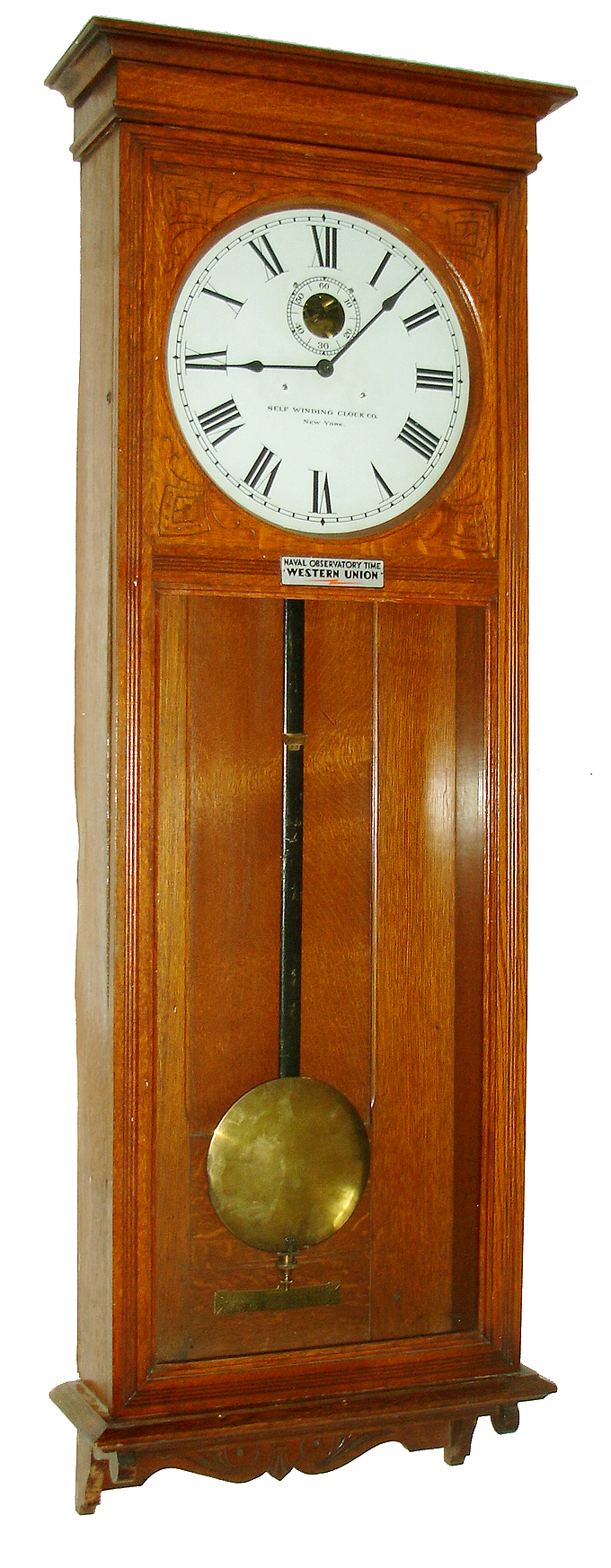 Self Winding Clock Co., New York, N.Y., "No. 9 Self Winding Regulator" wall clock, time only, electric movement with a 60 beat pendulum in an oak case with painted metal dial, c1908 — Antique Clocks Price Guide
