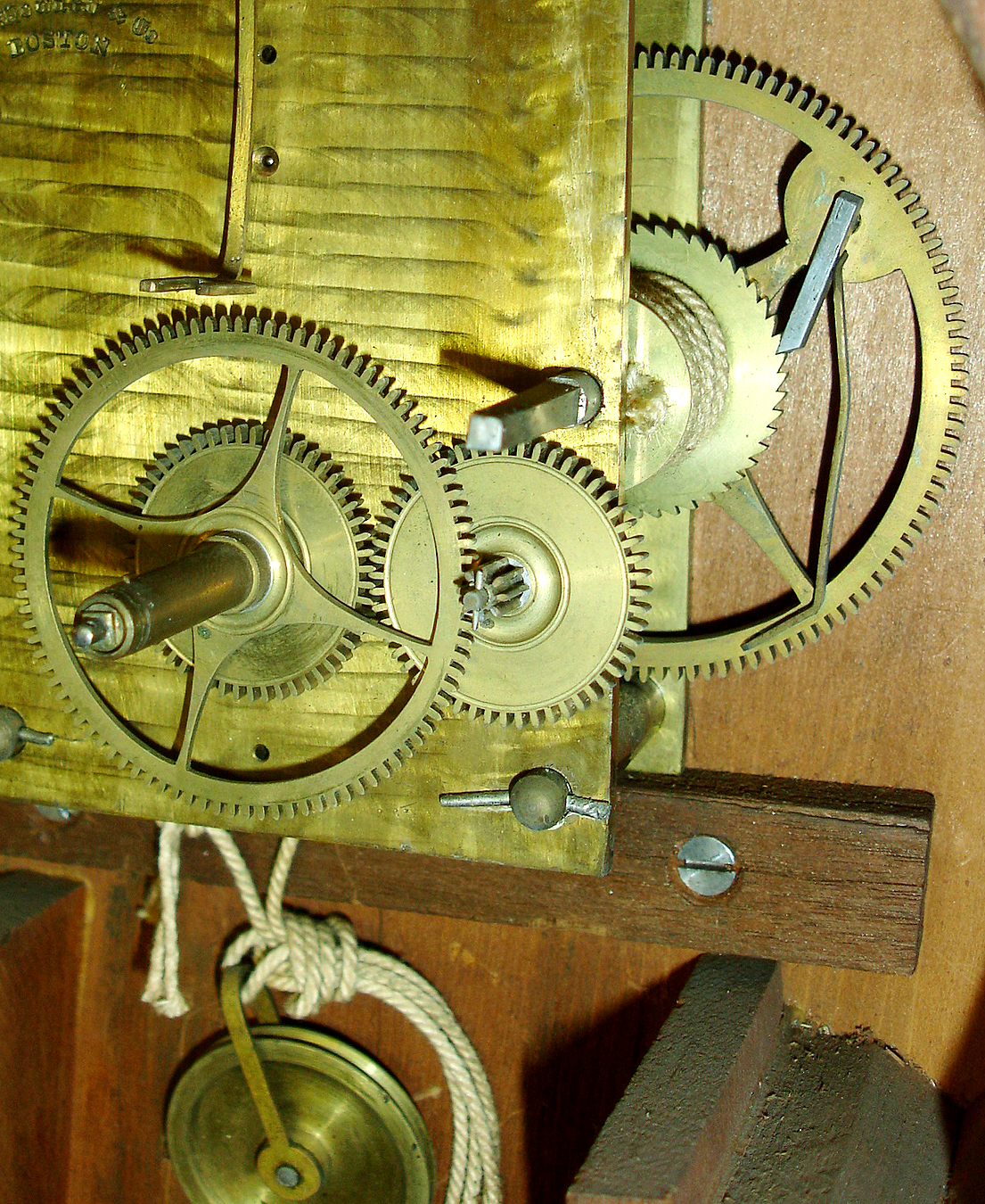 E. Howard &amp; Co., "Regulator No. 4" wall clock, cherry banjo style case with rosewood graining, throat and door glasses with gilt, red, and black decoration, signed Roman numeral white painted metal dial, blued steel moon hands, signed damascened movement, correct cast iron weight, pendulum with wooden rod and damascened ball, red painted weight baffle, case bottom with Howard instruction label, c1875 — Antique Clocks Price Guide