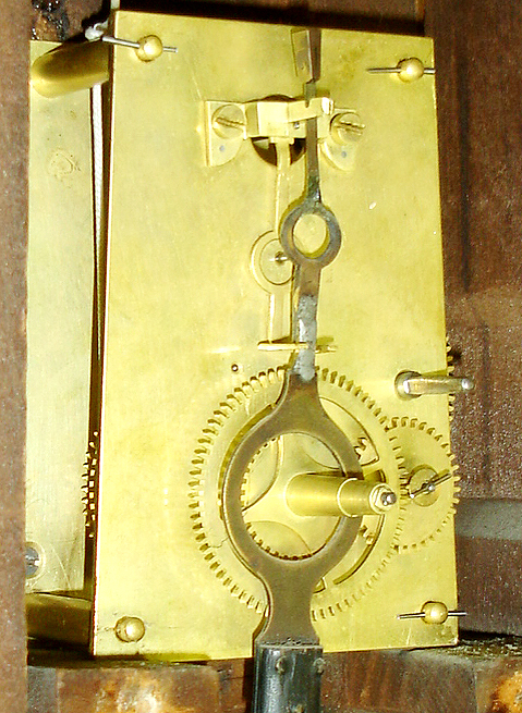 Baltimore banjo wall clock, attributed to George Hatch, North Attleboro, Mass., case with rosewood graining, asphaltum backed glasses with gold leaf decoration, Roman numeral white painted metal dial, correct and probably original blued steel Tulip style hands, brass 8 days, timepiece movement, original iron weight with tapered wooden plug for securing weight in transport, gilt wooden pendulum rod, brass pendulum ball, c1855 — Antique Clocks Price Guide