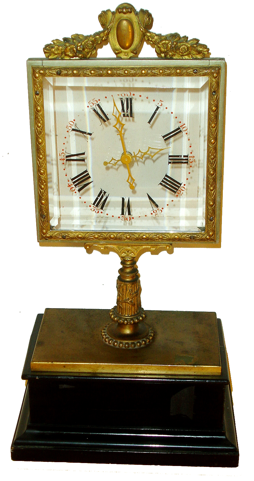 Jean Eugene Robert Houdin, Paris, fifth series mystery clock, ebonized rectangular ogee molded wooden base topped with a gilt brass platform, the center with short column supporting the square beveled glass dial with pierced brass hands, enclosed in an ornate, cast gilt frame with cartouche and floral garlands at top, 8 days, time only movement with platform escapement hidden in wooden base, and with gilt brass bottom cover, c1860 — Antique Clocks Price Guide