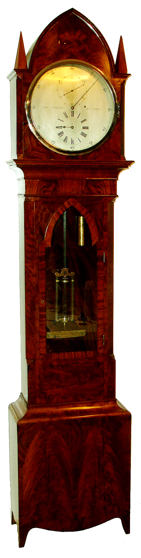 John Stokell, New York, New York, standing astronomical regulator, in a Gothic style mahogany and mahogany veneer case, the base with figured lancet arch veneer panels, the arch design carried through the glazed door and bonnet, case back also with crotch mahogany veneer and silvered beat scale, silvered astronomical dial signed "JOHN STOKELL NEW YORK", with blued steel hands, massive 8 days, time only, weight driven movement, all mobiles with adjustable end pieces dead beat escapement, Harrisons maintaining power, and with removable dust shields, crutch with fine beat adjustment at top, with a mercury single jar pendulum with fine adjustment weight at bottom, c1855 — Antique Clocks Price Guide