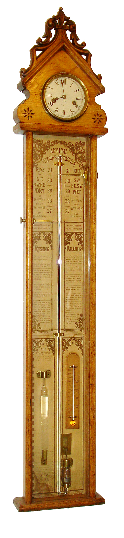 Admiral Fitzroy barometer, ash case with gothic style carving at top, glazed front, printed paper for backboard with barometer scales, tips for interpreting the information shown, thermometer, and storm glass, top of case with clock, Roman numeral painted dial, 8 days, marine timepiece by E.N. Welch and back with label and instructions, c1880 — Antique Clocks Price Guide