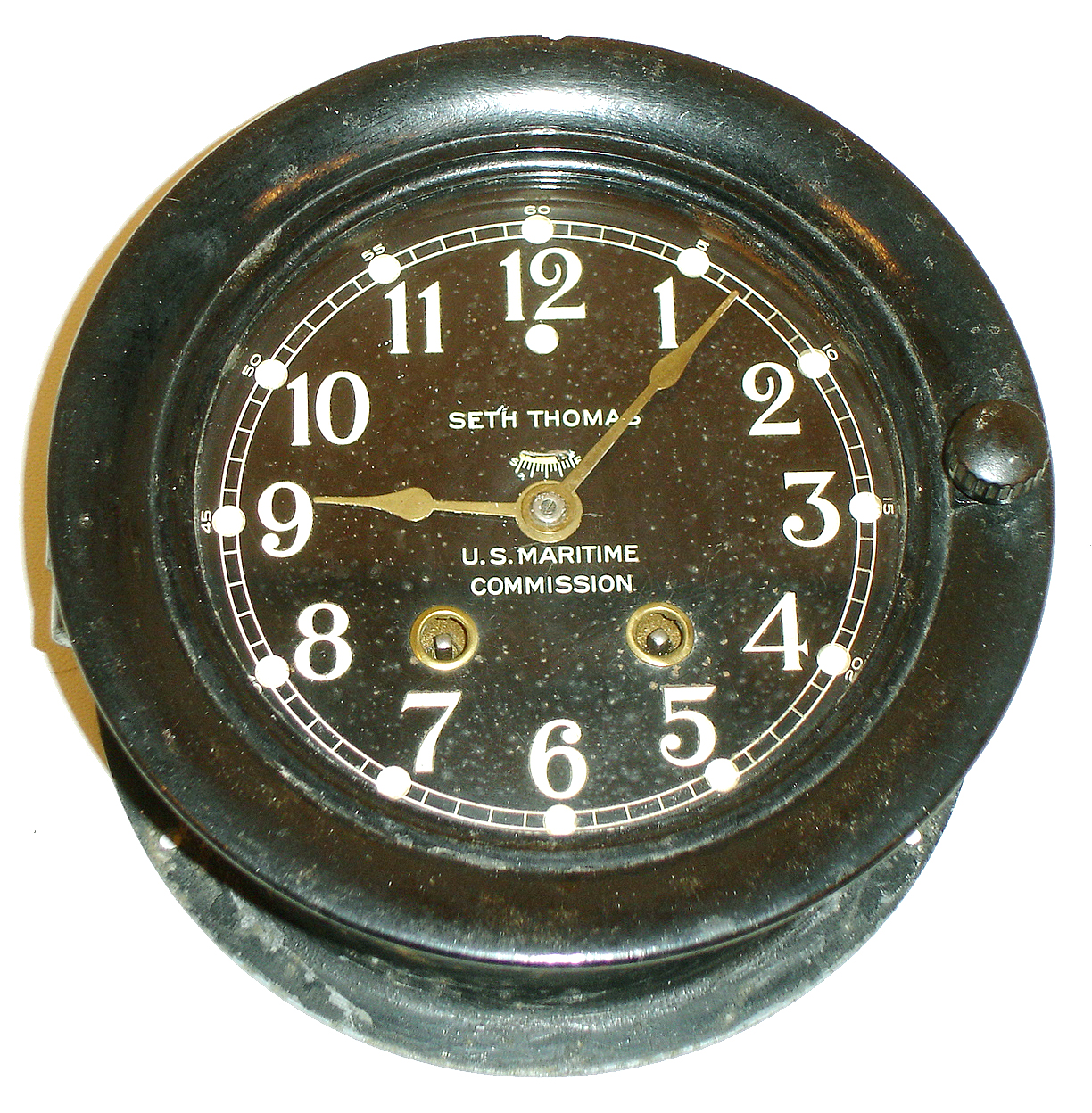 Seth Thomas Clock Co., Thomaston, Conn., ship's bell wall clock made for U.S. Maritime Commission, 5" dial, 8 days, time and ship's bell strike, spring driven movement in a cast iron case with phenolic bezel, c1940 — Antique Clocks Price Guide