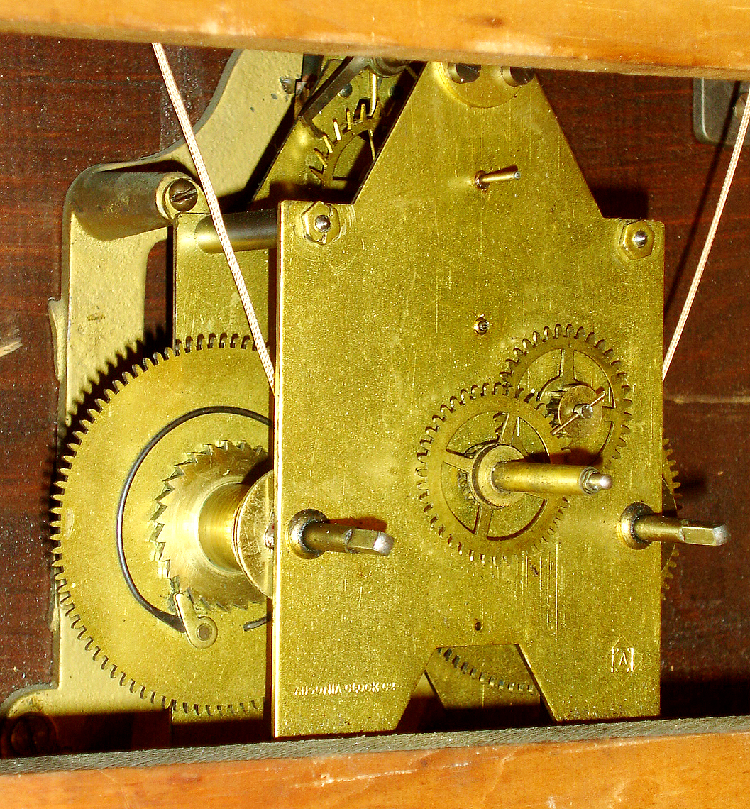 Ansonia Clock Co., New York, N.Y. "General" wall clock, 8 days, time only, two brass weight driven movement in an oak case with painted metal dial, c1886 — Antique Clocks Price Guide