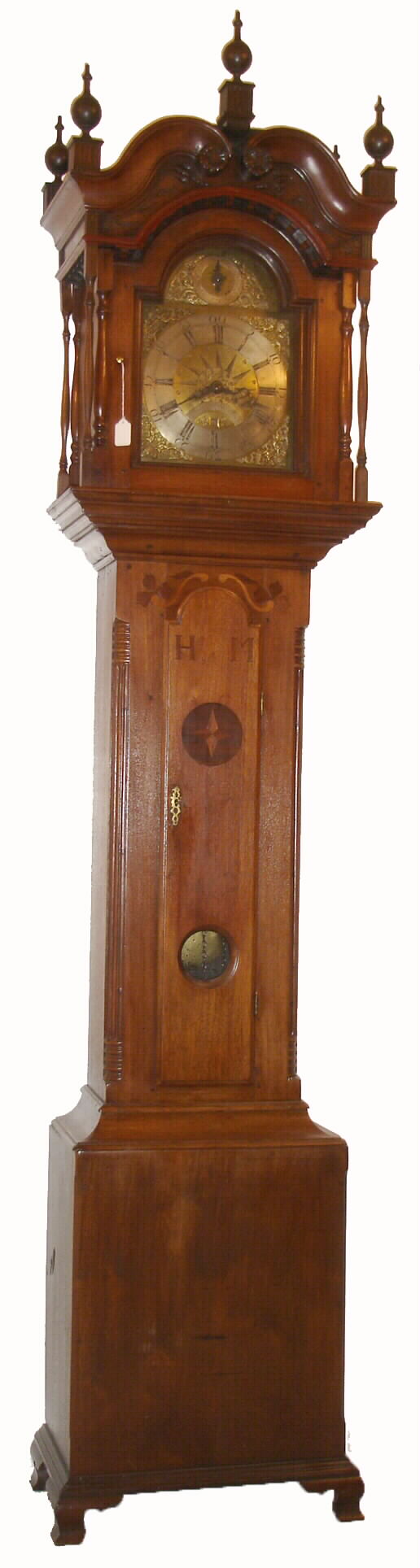 Henry Gotshalk, Allentown, PA, inlaid walnut cased tall clock, with dentil work, bonnet top, 5 finials, and carvings. This is a 30 hours, arched brass dial, with compass motif, and with strike / silent dial in the arch, &amp; calendar aperture above 6, from the Doug Shaffer collection, c1765 — Antique Clocks Price Guide