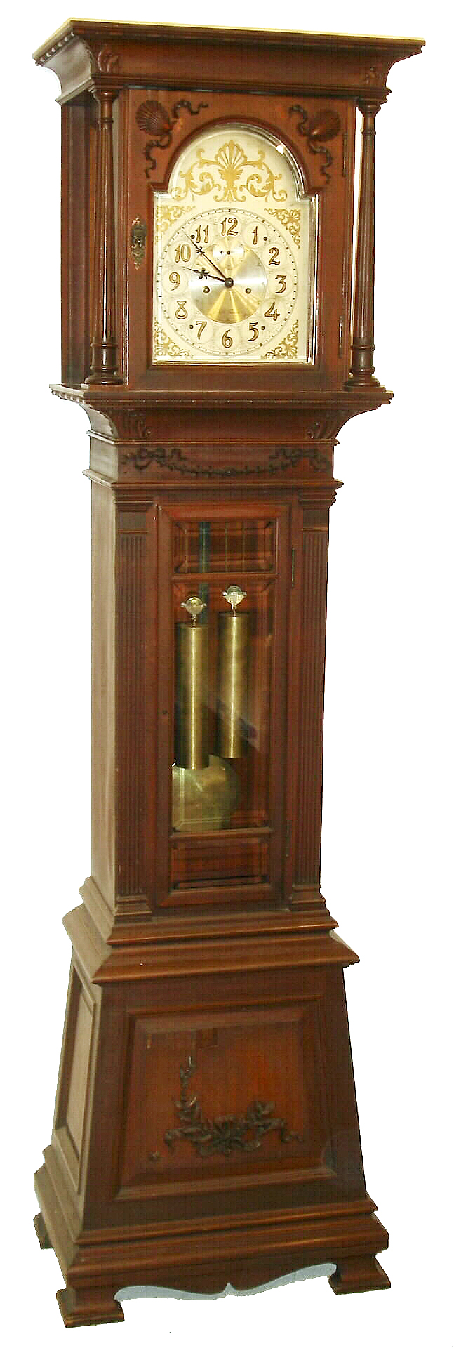 Seth Thomas Clock Co., Thomaston, Conn., "Hall Clock No. 24" tall clock, 8 days, time and gong strike, brass weight driven movement in a mahogany and mahogany veneer case with beveled glasses, reeded full columns on hood, splayed plinth with variant OG bracket feet and flat reeded columns flanking trunk door and silvered brass dial, c1900 — Antique Clocks Price Guide
