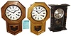 Clocks- 5 (Five) reproduction 8 days, wooden wall clocks: two Korean Montgomery Ward 30-day time and strike, school clocks; Standard time and strike; Daneker 8 days, chiming large school clock; ornate double-dial time and calendar; late 20th century