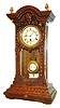 German miniature shelf clock, 8 days, time only, spring driven movement in a carved walnut case with white enamel dial and enameled R/A pendulum bob and indicator, c1875
