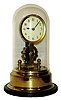 German Eureka, battery powered, electro-magnetic clock mounted on brass base under dome with large exposed rotating balance, c1910