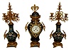French, 3-piece mantel clock set, porcelain urn shaped case with matching torchier/candle stand side pieces.  The 3 porcelain pieces are cobalt blue with light blue and pink decorations in the Nouveau style. The time and strike, movement with a platform lever escapement, seems intact, c1905