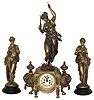French 3 piece mantel garniture, the clock case with with classical ornament and figure of Diana, the flanking female figures with with similar dress, one contemplating a birds nest with eggs, the other with bunches of grapes, each mounted to a turned, ebonized wooden base, Roman numeral white enamel dial with recessed center and visible Brocot escapement with jeweled pallets, blued steel Breguet style hands, 8 days, time and strike, Pendule a Paris movement, c1880