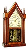 Terry & Andrews, Bristol, Conn., four posted steeple or "Sharp Gothic" mantel clock, 8 days, time and strike, brass spring driven movement in a mahogany veneer case with painted metal dial and reverse painted tablet, c1850