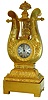 French mantel clock, gilt bronze lyre form case with pendulum oscillating behind the "strings", ornamented with gilt mounts of waterleaf, anthemion, and horn of plenty with an overflowing fruit basket at top, scallop shell bezel, pendulum also decorated with scallop shells and sea horses, 8 days, time and strike, Pendule a Paris movement, Roman numeral, engine turned, silvered dial, blued steel Breguet style hands, c1830