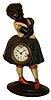 Bradley & Hubbard, "Topsy" blinking eye novelty clock, cast iron figure with blue painted dress, white blouse with red trim, white stockings and red shoes, Roman numeral paper dial, 30 hours, lever movement with linkage to move the eyes, c1860