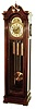 Colonial Manufacturing Co., Zeeland, Mich., tall clock, 8 days, time, strike and Westminster chime, three brass weight driven, large Winterhalder Hofmeier German movement in a mahogany case with beveled glass door and broken arch top. The silvered brass dial has applied numerals, moon phase, strike & chime silent selectors, and brass spandrels, c1910