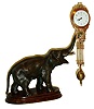 Junghans, Germany, "Elephant" model swinger, 8 days, novelty timepiece, the patinated spelter elephant mounted to a molded beech wood base, his trunk supporting clock with compound pendulum, white enamel Arabic numeral dial with Junghans logo, blued steel hands, 8 days, time only movement, signed "Junghans Germany",ca.1920