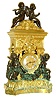 French gilt and patinated bronze mantel clock, base with scrolls and Adamesque vines, corner pilasters with fancy capitals, female mask above dial, squirrel, compote with fruit, and bird in frieze, acanthus leaf cornice, and top with stepped plinth, case sides with niches containing urns, base and top each with 2 patinated putti, the lower figures bearing swags of fruit, Roman numerals on ceramic cartouches mounted to gilt dial, blued steel hands, 8 days, time and strike, Pendule a Paris movement signed "Douillon", and "Christophle a Paris", c1850