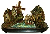Swiss or German, country scene automata with painted card stock buildings, windmill, grist mill, and a tall ship, all powered by a concealed movement with 2 tune music box, the water wheel and windmill rotating as the ship rocks on the sea, with painted paper mache landscape, and on an ebonized base with glass dome, the inside painted with sky and a ship in the distance, c1870