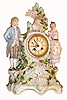 French, for J. E. Caldwell, Philadelphia, fine porcelain china bride's clock, showing Mom & Dad to the sides and with bust of daughter at top, the mother holding a tablet with vows, the whole surround by flowers with fine individual petals, and the quality 8 days, bell strike movement by S. Marti, with Caldwell info, c1890
