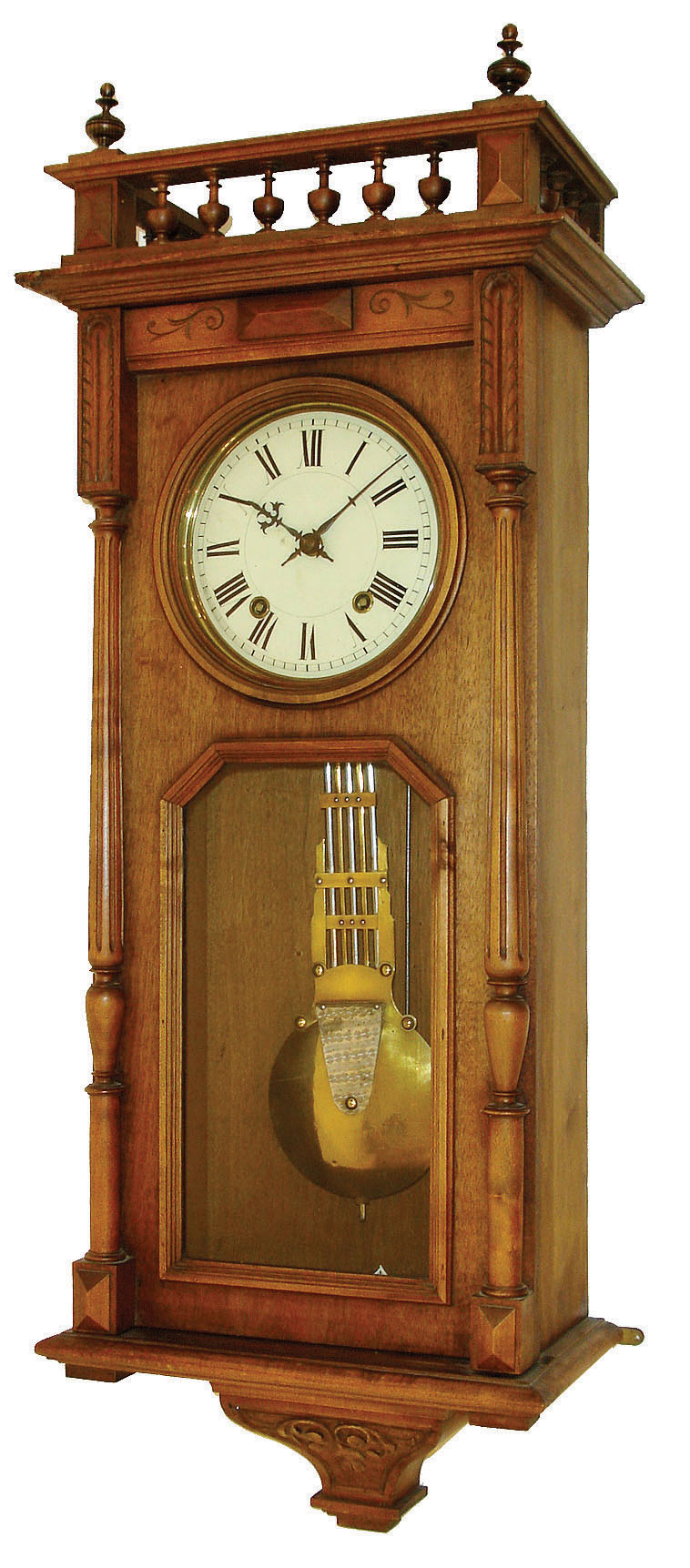 France, walnut cased wall clock, with Morbier iron framed repeating movement, the case top trimmed with a balustrade and glass in the door revealing unique grid iron pendulum, striking the hours on a straight wire gong, and repeating the hour strike 2 minutes later. C.1910 — Antique Clocks Price Guide