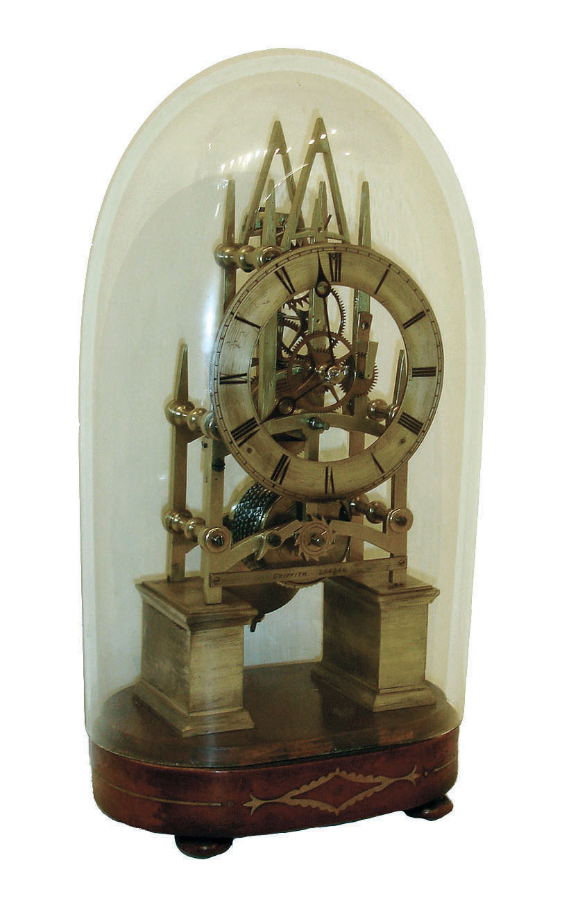 English made single chain fusee skeleton timepiece in a sharp Gothic frame with 6 heavily turned baluster pillars, and a solid silvered chapter ring and pierced lancet hands, c1840. Silvered engraved brass cross piece indicating it was retailed by Griffiths of London. — Antique Clocks Price Guide