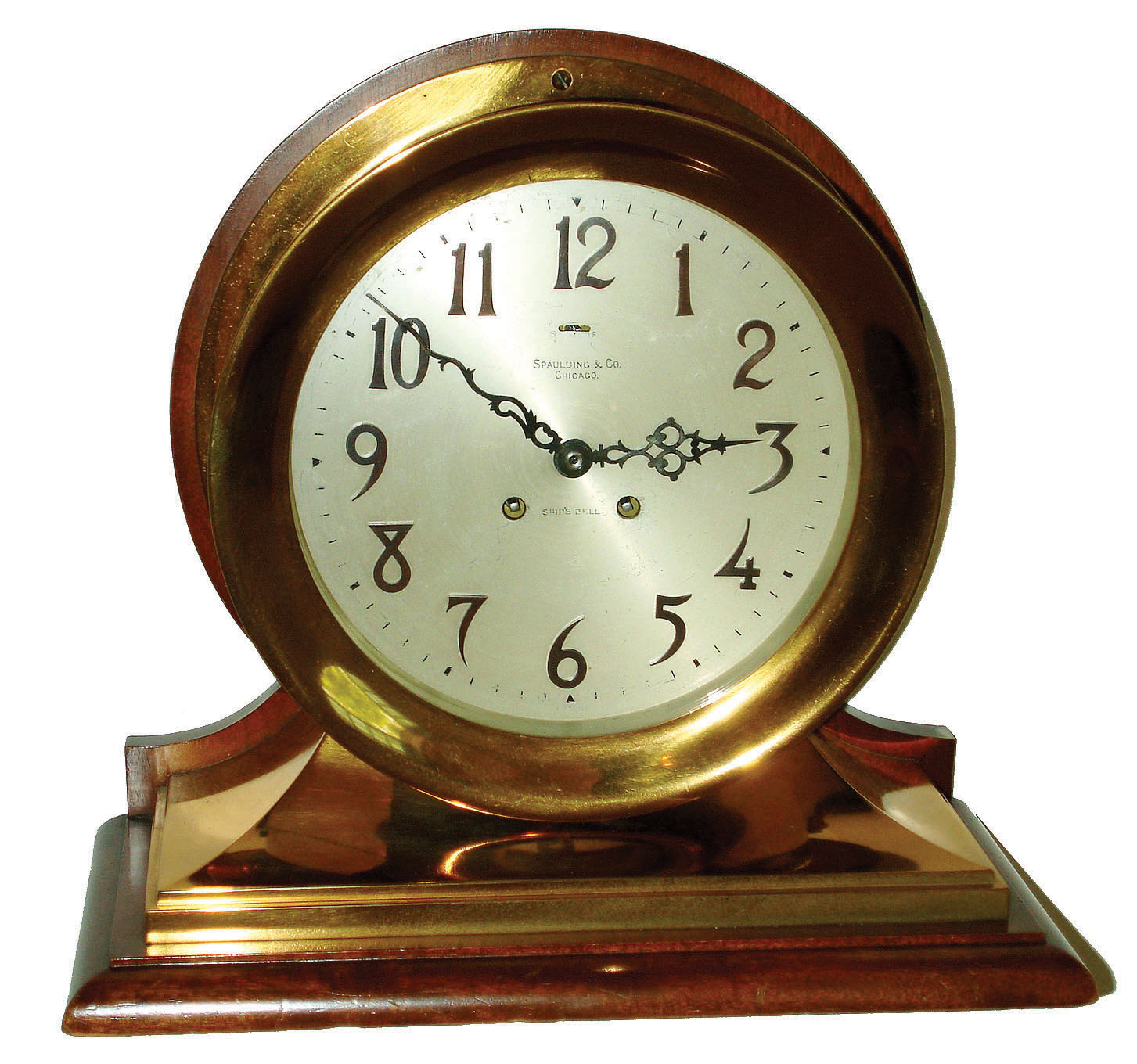 Chelsea Clock Co., Boston, "Commander" 8 1/2" dial 8 day ship's bell striking brass case on mahogany base mantel clock retailed by Spaulding &amp; Co., Chicago, 1908. — Antique Clocks Price Guide