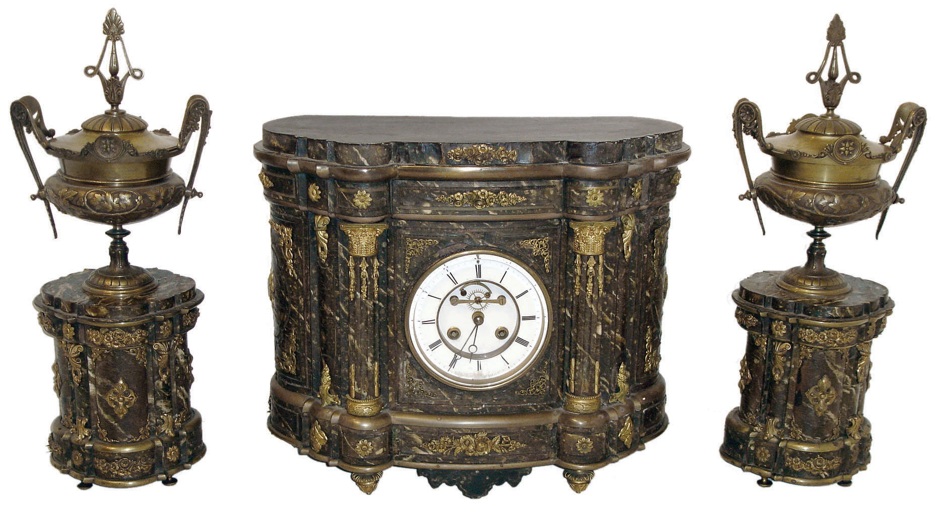France, 3 piece mantel garniture, dovetailed oak clock case with underpainted horn veneer, colored to appear as marble, with gilt mounts and moldings, and extensive use of brass line inlay, Roman numeral white enamel dial with open Brocot escapement, blued steel Breguet style hands, 8 days, time and strike, pendule a Paris movement, back with brass framed glazed door, the plinth form side pieces with finishes and ornament matching the clock case, and supporting covered, cast brass urns with foliate and Grecian style ornament, c1870 — Antique Clocks Price Guide