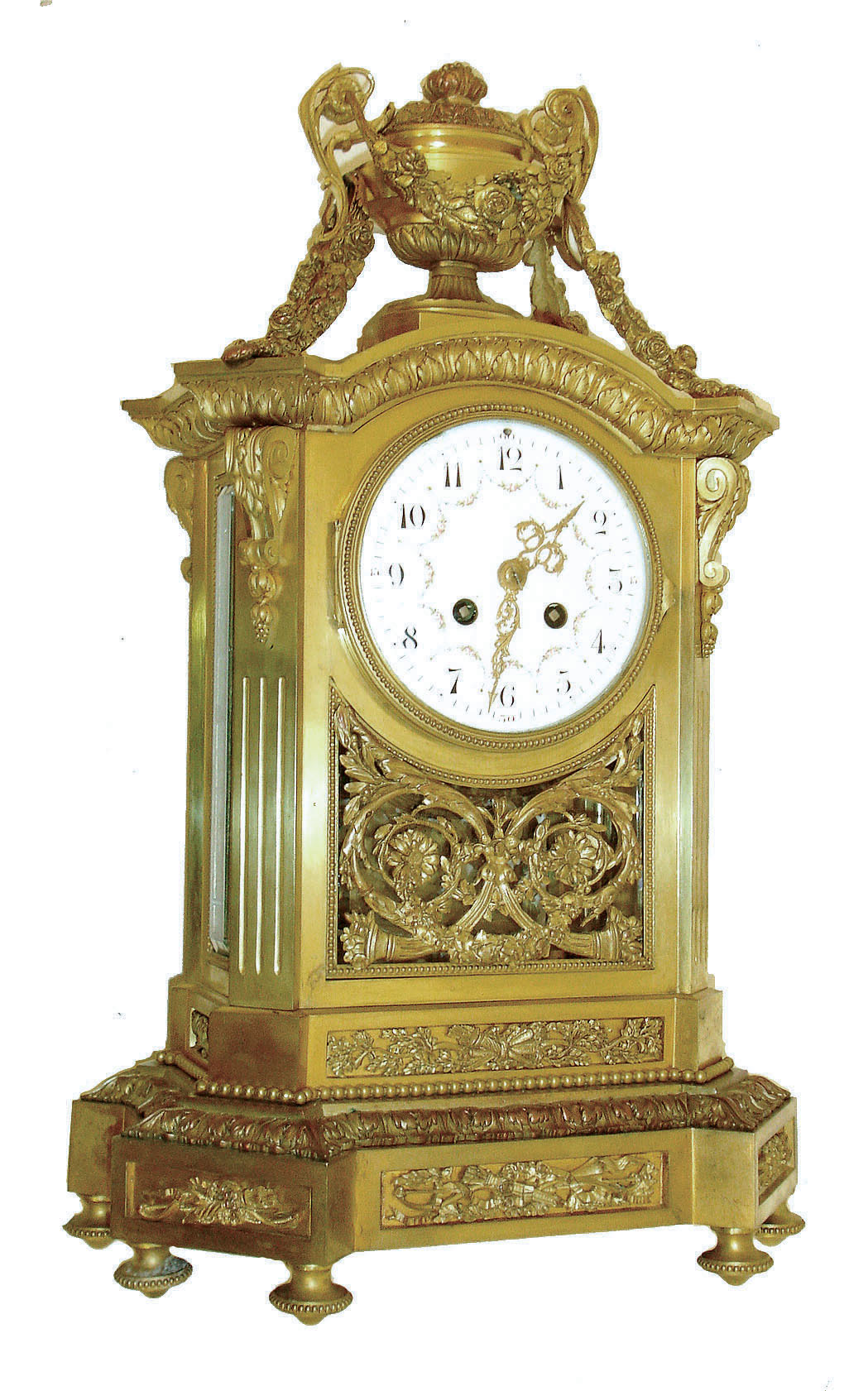 France, large gilt bronze mantel clock, with beveled glass sides, adorned with scrolls and swags in the Louis XVI style, the well made pendule a Paris movement bearing the imprint signature of Samuel Marti, the whole setting on a 16 sided base, with floral frieze, and surmounted by a large 2 handled urn draped to the base with floral swags, C.1900 — Antique Clocks Price Guide